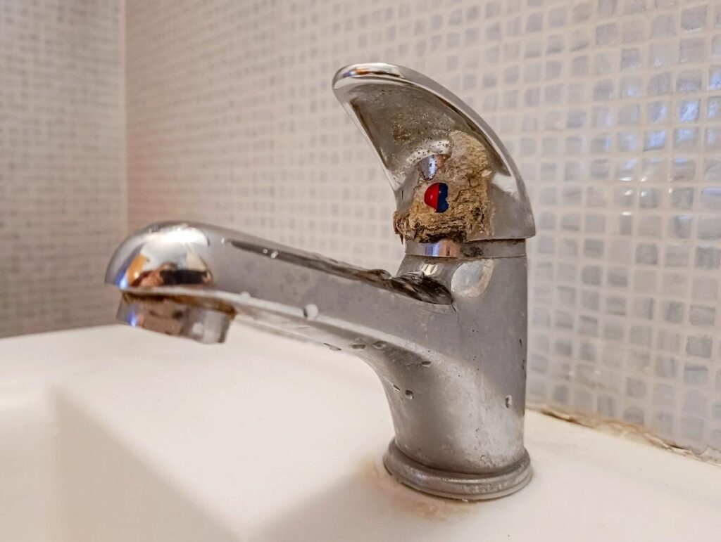 buildup on a bathroom sink faucet