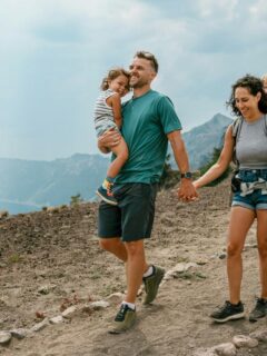 couple hiking with their baby and toddler