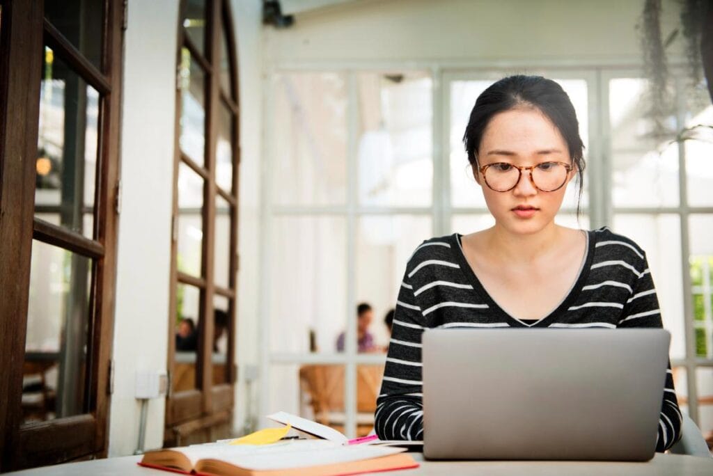young woman with laptop studying