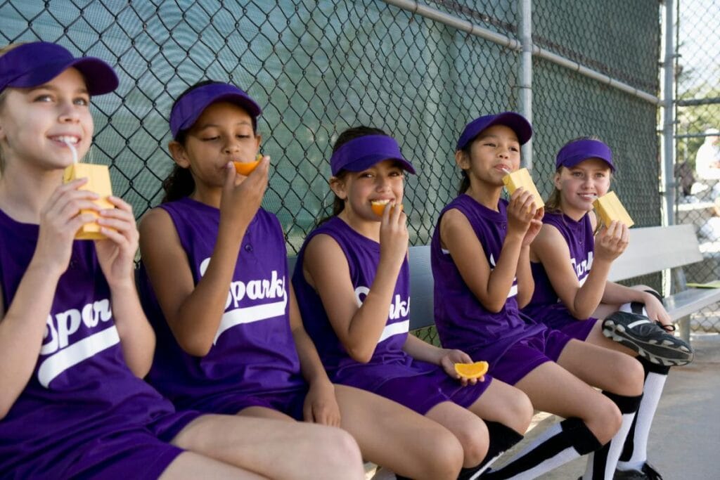 girls softball team having a snack