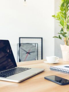 laptop and notebook on desk in home office