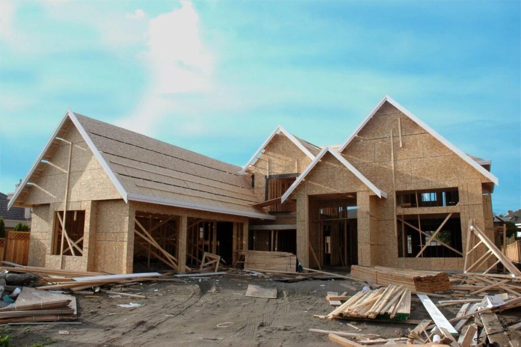 New house under construction with timber framing and exterior sheathing