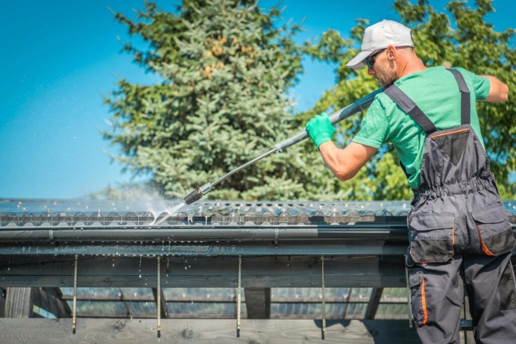 man cleaning gutters