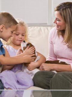 mom and kids on couch with new puppy