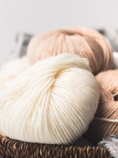balls of neutral-colored yarn in woven basket