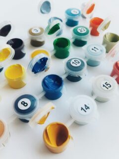 small paint containers with number stickers perfect for a paint by numbers kit
