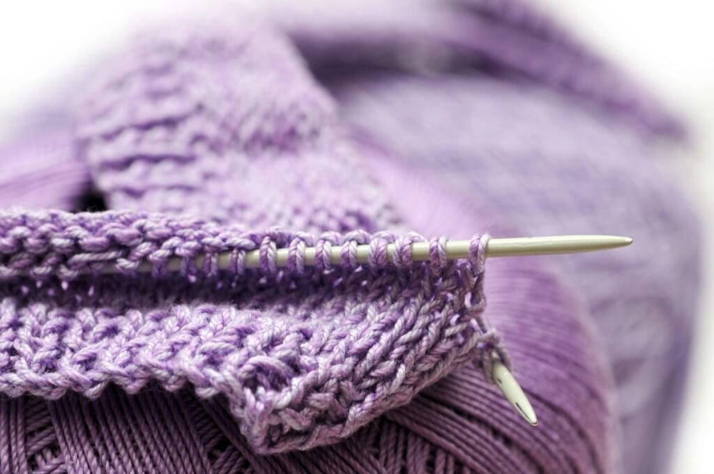 knitting with purple yarn