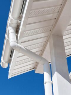 white fascia and gutter against blue sky