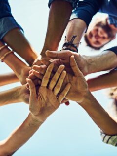 all hands in on team building exercise