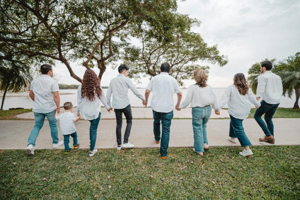 family wearing matching outfits of white shirts and denim bottoms