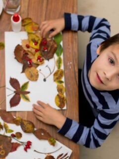 boy making crafts out of leaves and other materials from nature