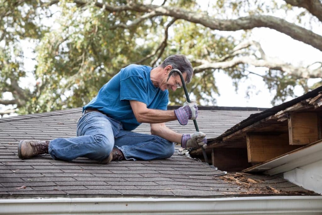 man looking at roof that needs repairs