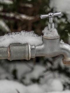 outdoor spigot covered in snow
