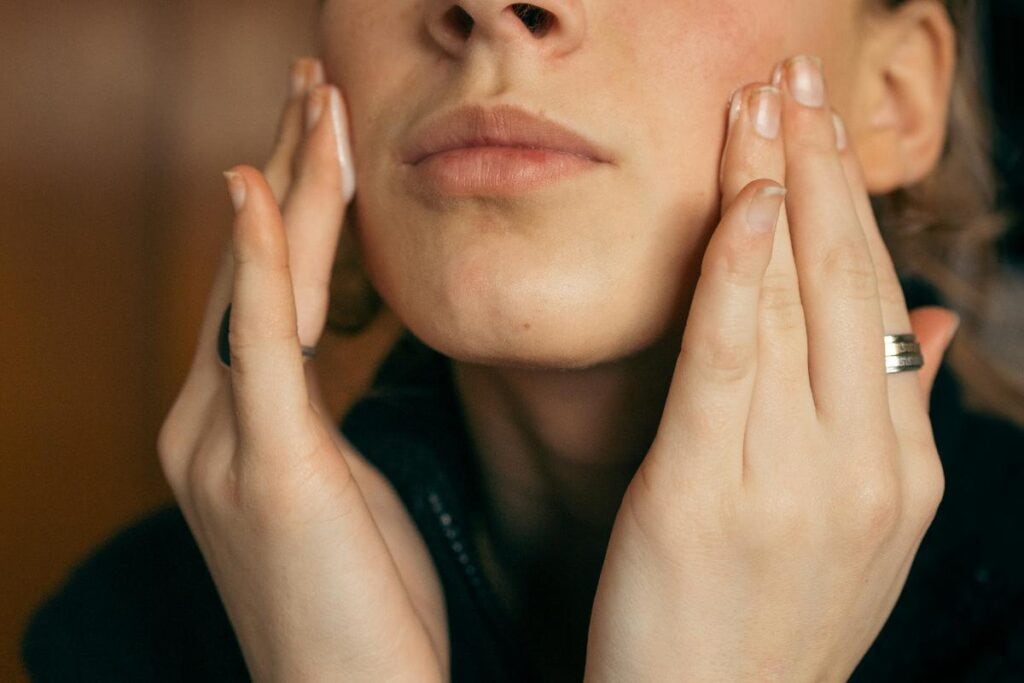 woman applying skin care product to face