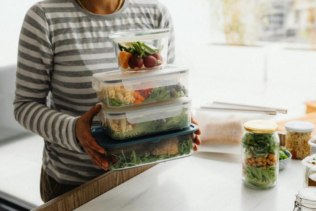 woman holding meal prep food for the week