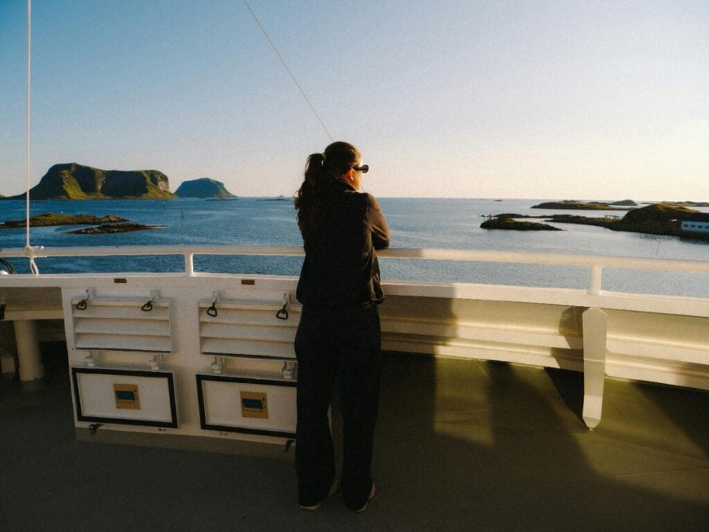 woman looking thoughtfully out over the water