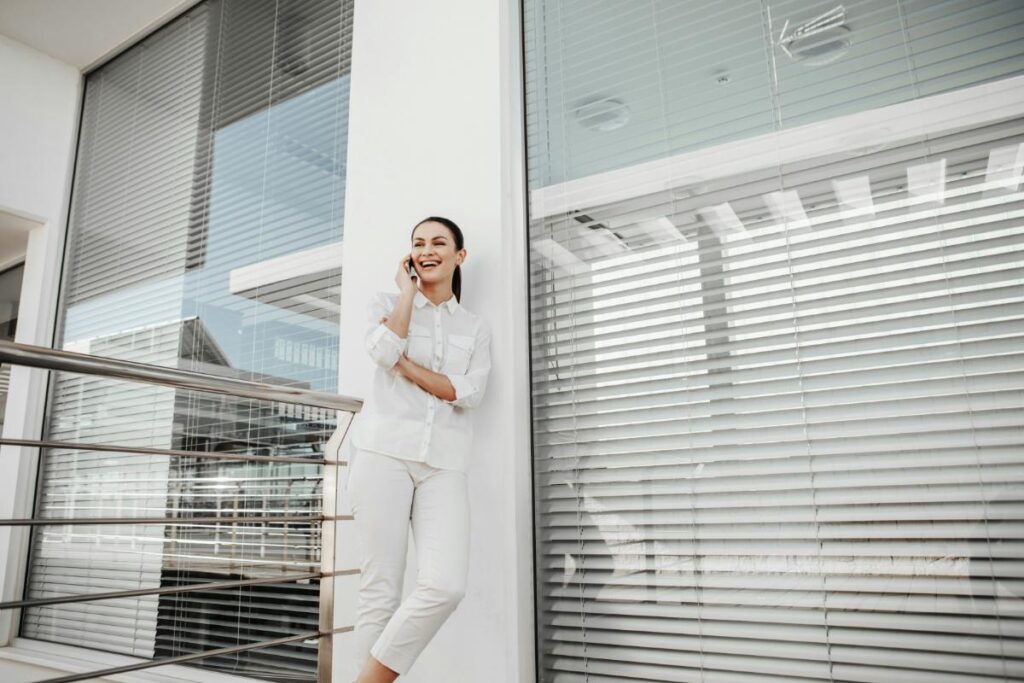woman outside of building with architectural louvre panels