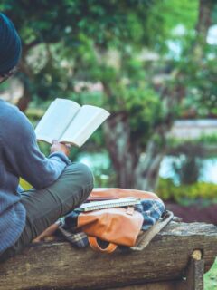young man reading outdoors